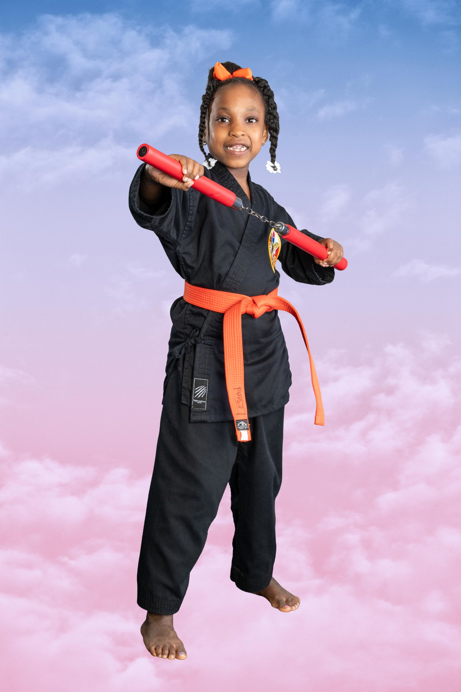 Young student against a pastel sky backdrop