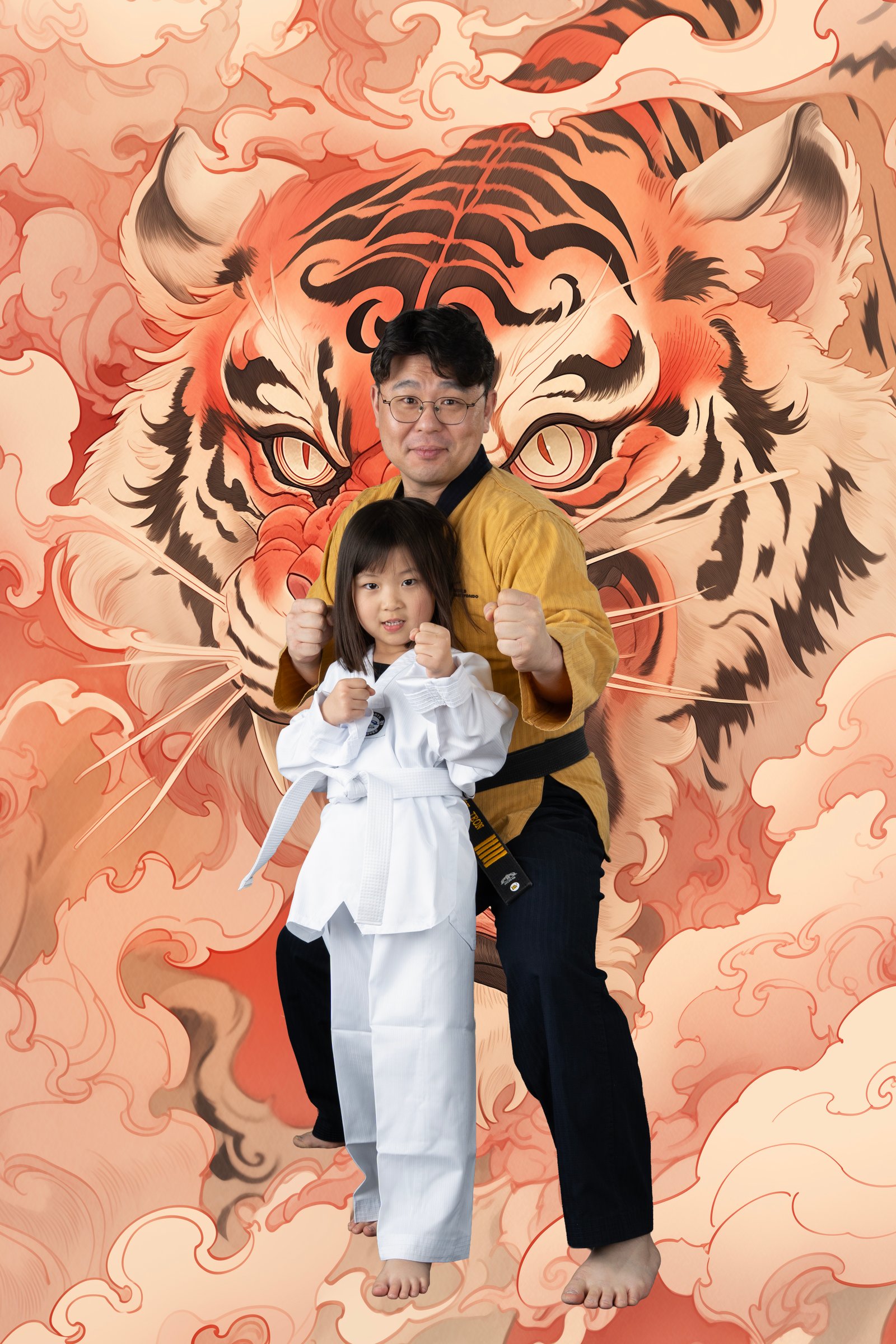 Parent and child portrait against a tiger mural background